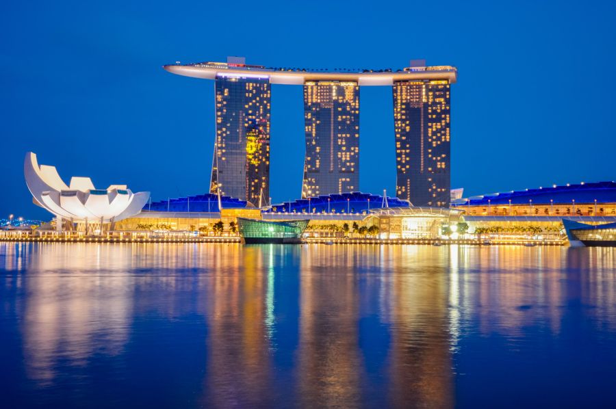 Marina Bay Sands illuminé à Singapour, reflété dans l’eau