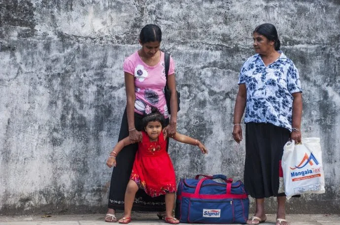family in front of kandy prison
