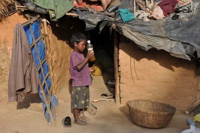 kid in front of house poor region bihar bodhgaya - india