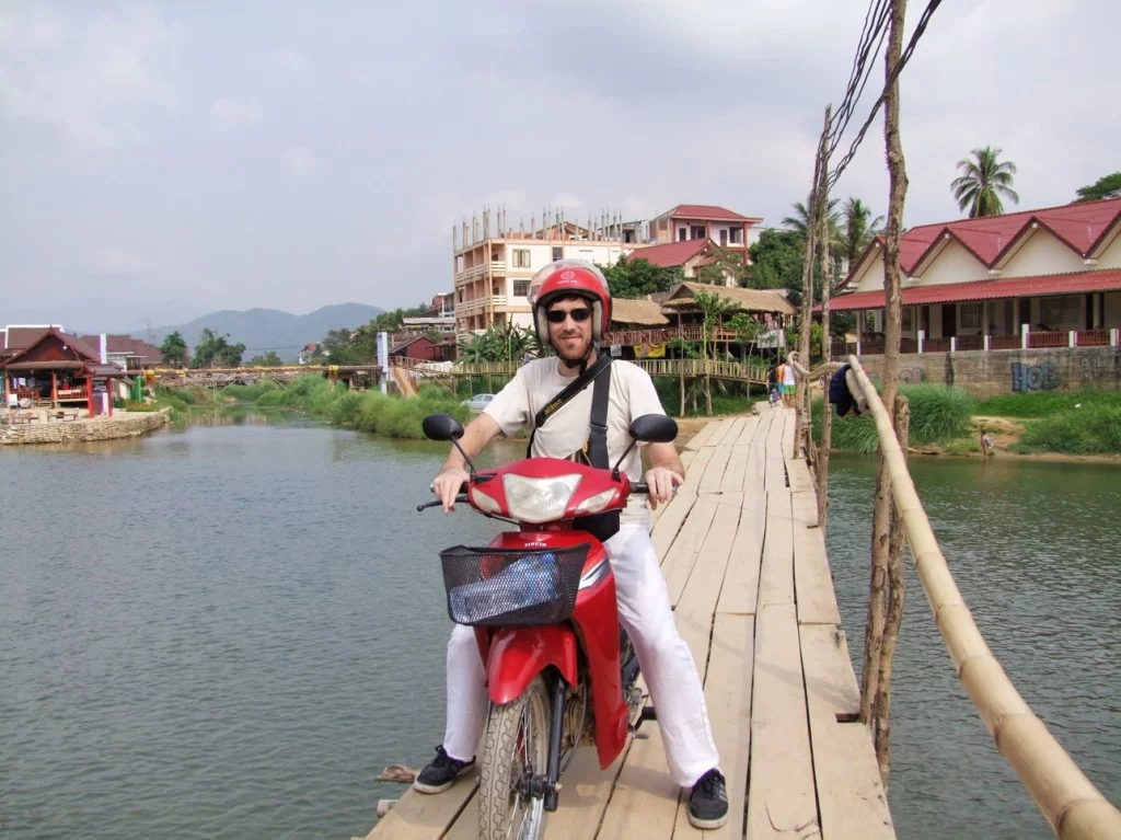 wooden bridge crossing the river in vang vieng
