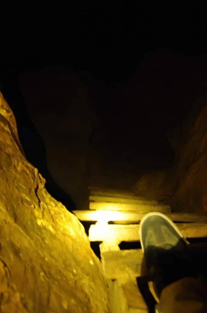 dark interior of a narrow cave in vang vieng