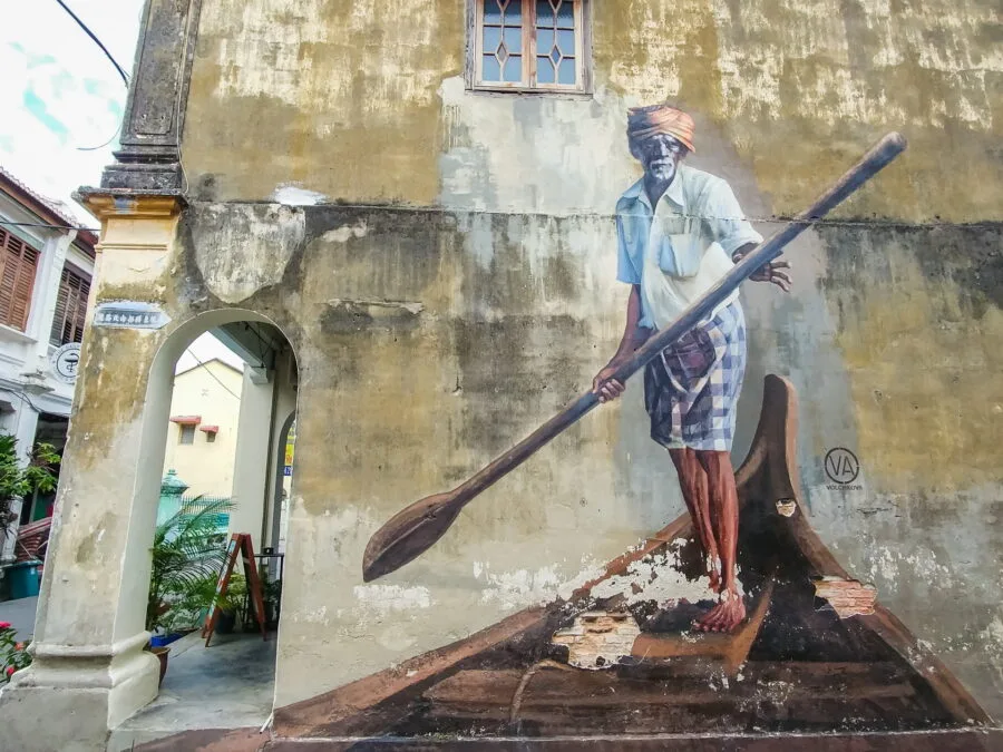 indian man on a boat street art penang