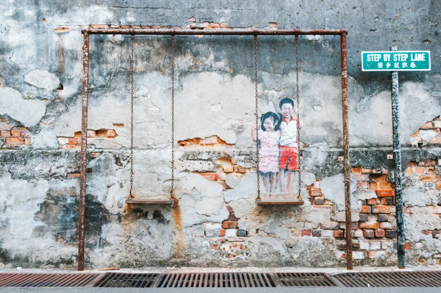 louis gan brother and sister on a swing street art penang