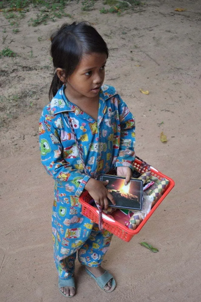 young girl 1 dollar Angkor temple Cambodia