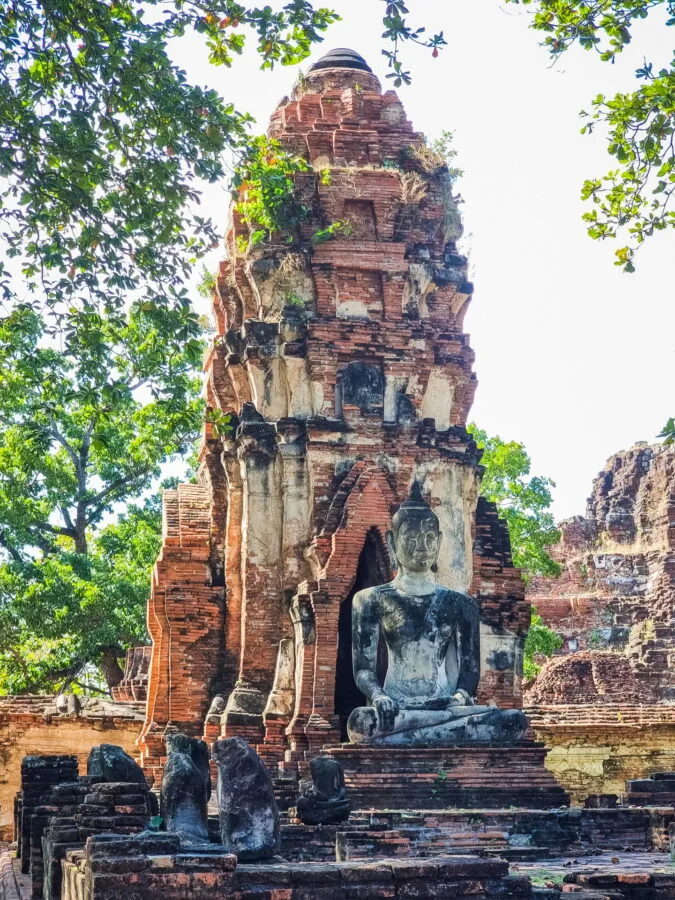 prang and buddha statue wat mahathat ayutthaya