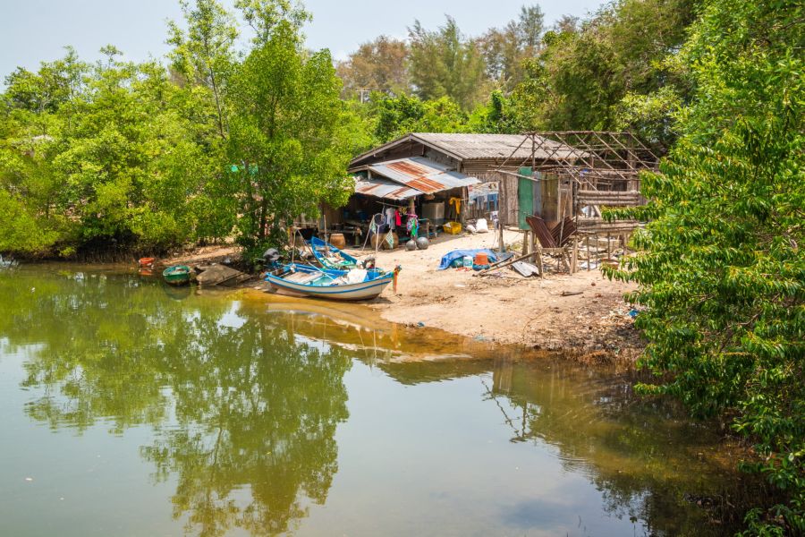 Fisherman's house and boats by a river