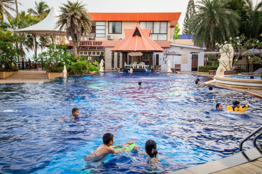 Children and families in a tropical hotel pool