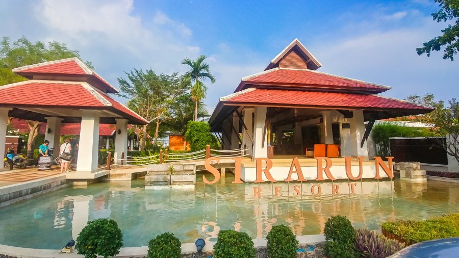 Entrance to the Sirarun Resort with pool and red roofs