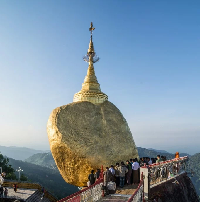 pilgrims at the foot of the golden rock of kyaiktiyo in burma