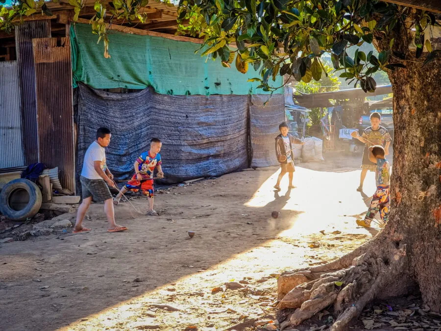children playing spinning tops in the village of Khun Chang Khian Doi Pui