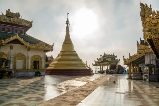 sun behind chedi mawlamyine burma