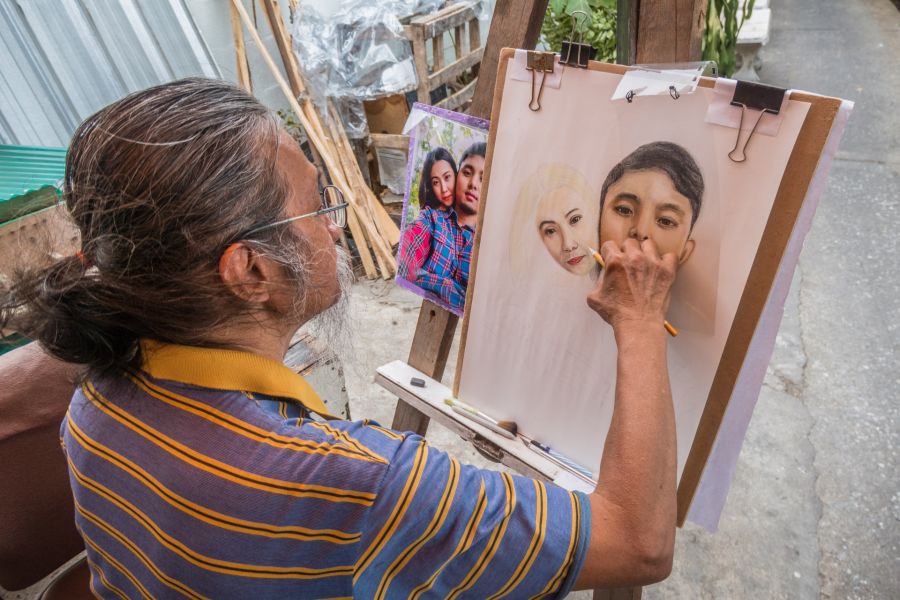 Artiste réalisant le portrait d’un couple d’après photo