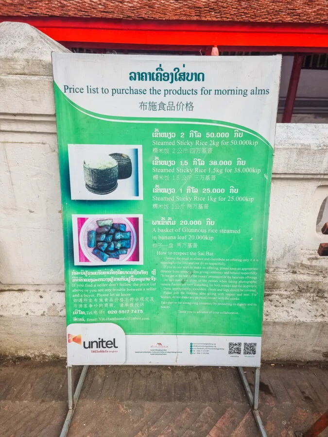 sign indicating price of tak bat offerings luang prabang