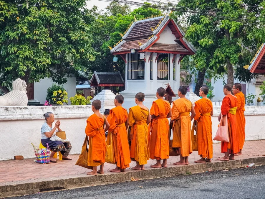 local prayer offering alms monks luang prabang