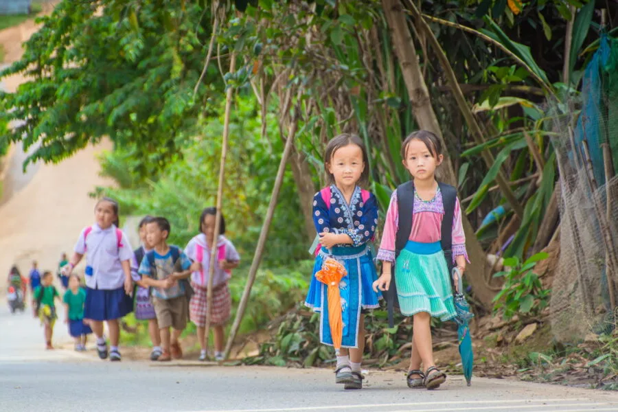 children leaving school on the road leading to doi hua mae kham