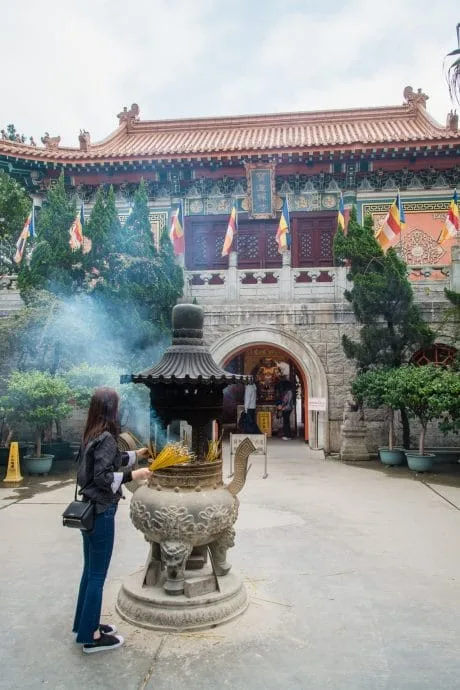 prayer in front of po lin monastery hong kong