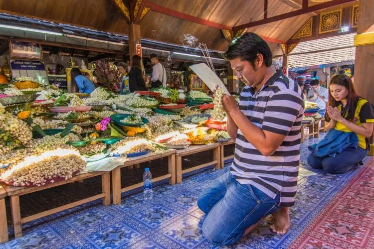 prayer at wat phra that doi kham - chiang mai