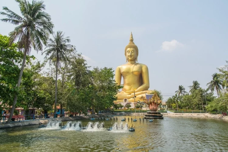 large buddha statue wat muang in front of pool - ang thong