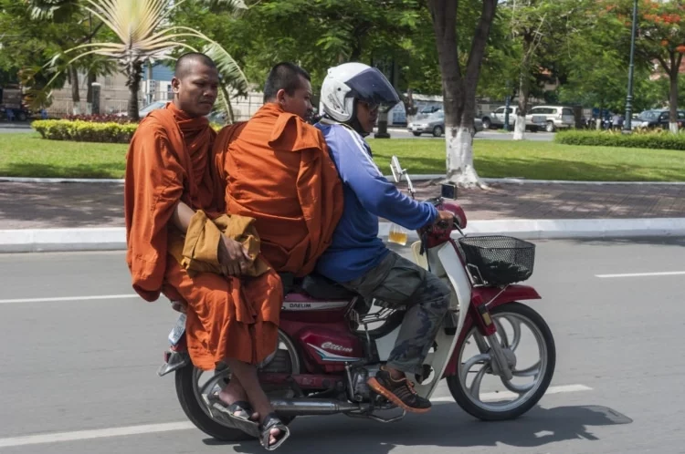 monks on motorbike phnom penh cambodia