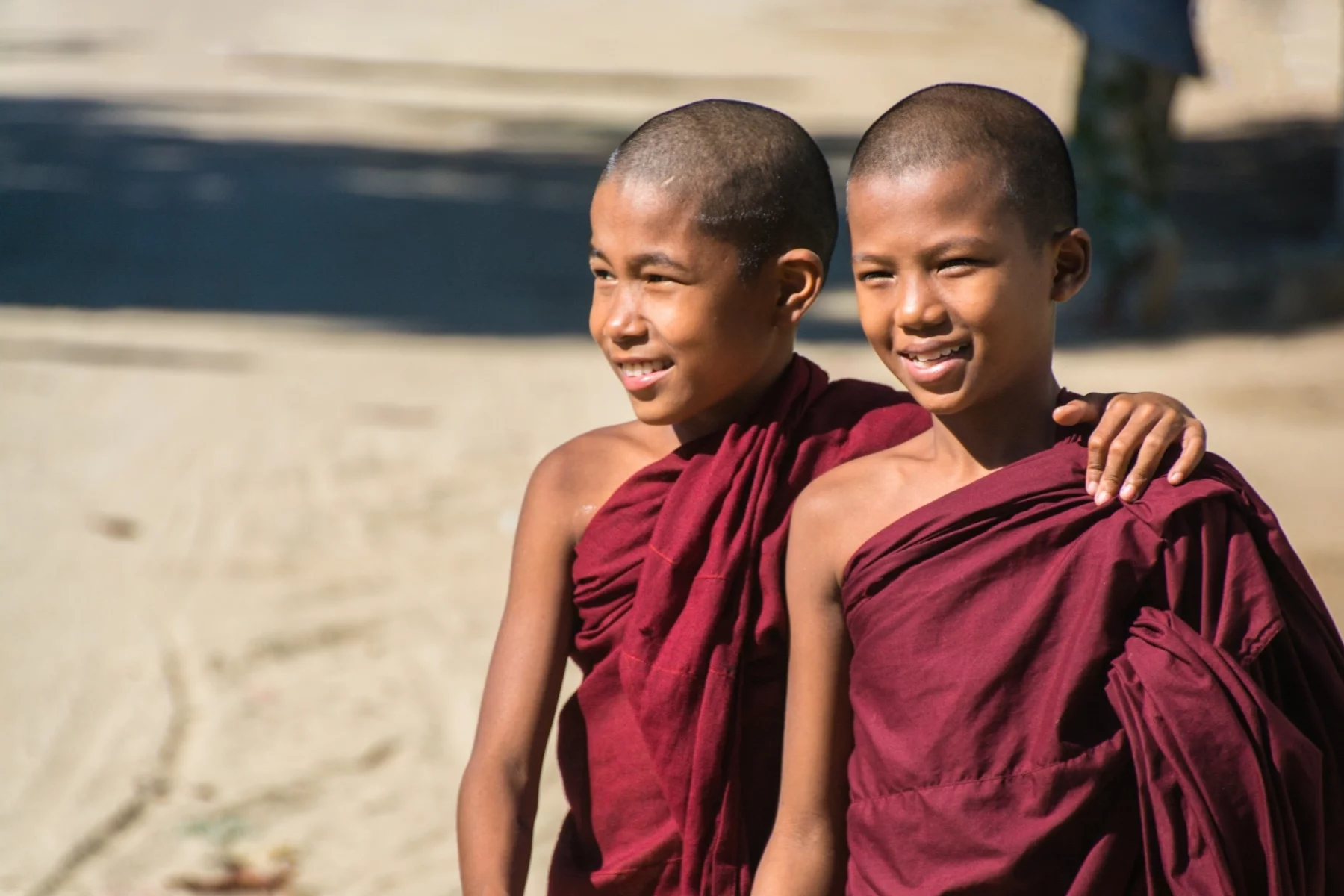 Two young Buddhist monks in a street in Chaung Tha