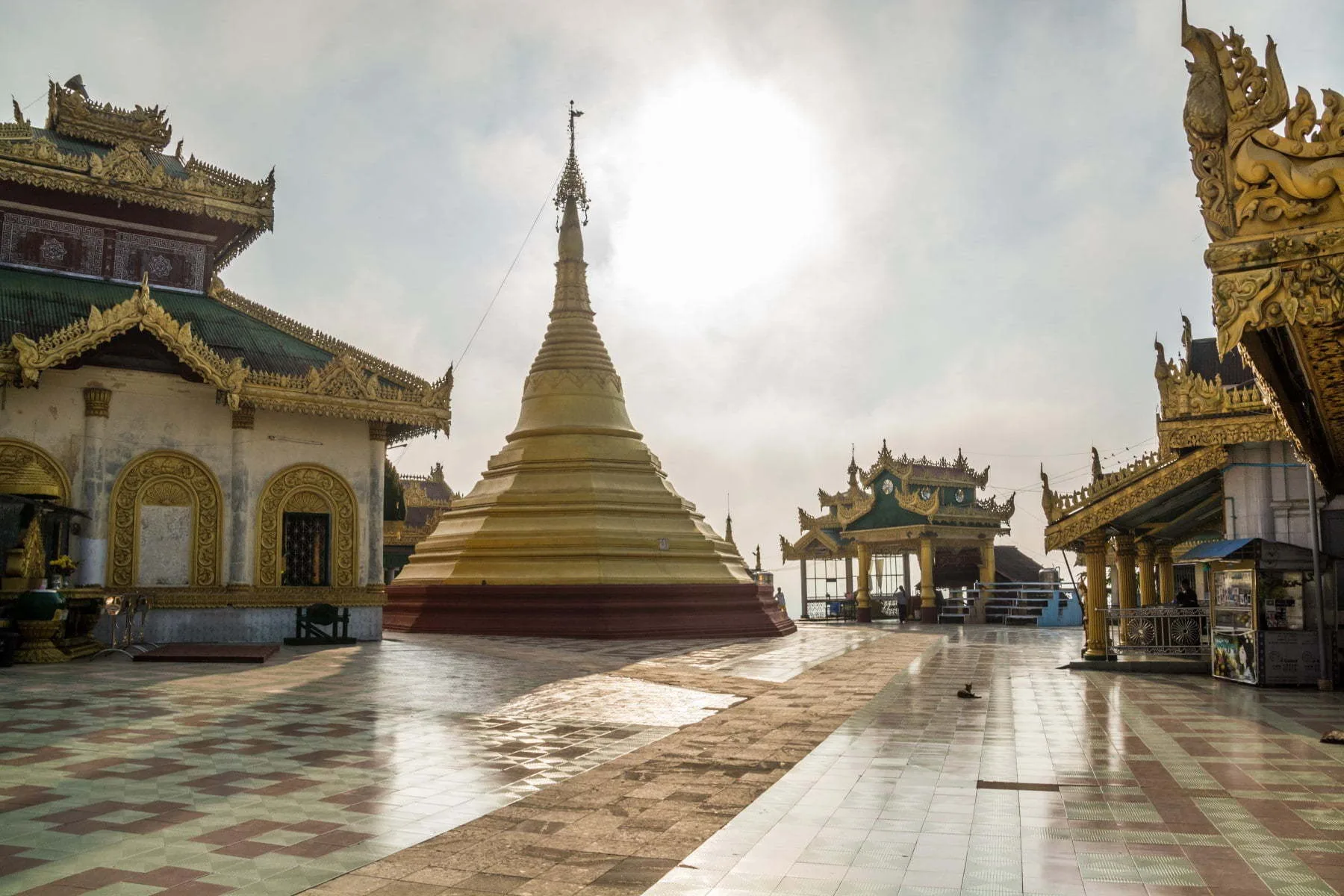 sun behind burmese stupa mawlamyine