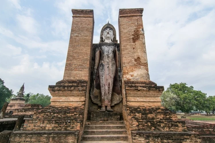 standing buddha wat mahathat historical park sukhothai - thailand