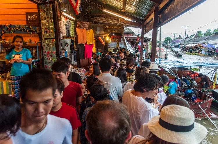 crowd along amphawa canal - thailand