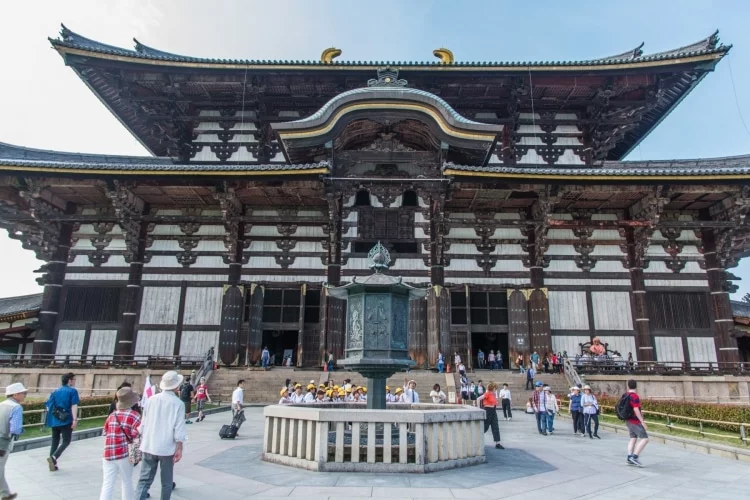 in front of lantern todai-ji temple nara - japan