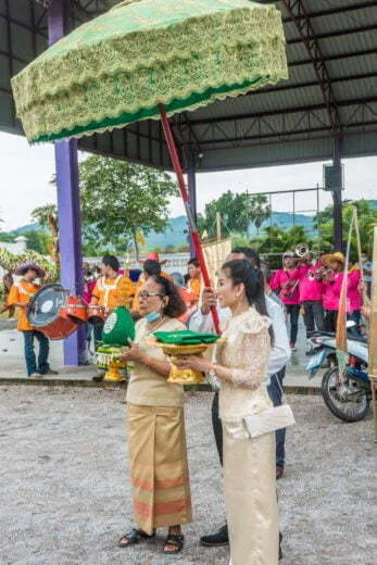 family participating ceremony kathina kanchanaburi