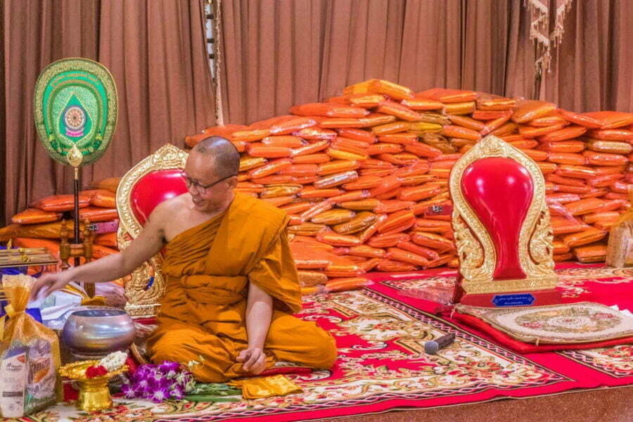 pile dresses behind abbot ceremony kathina kanchanaburi