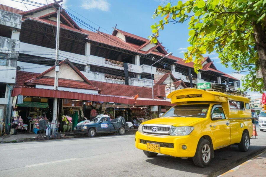yellow songtaew in front of your lam yai market - chiang mai