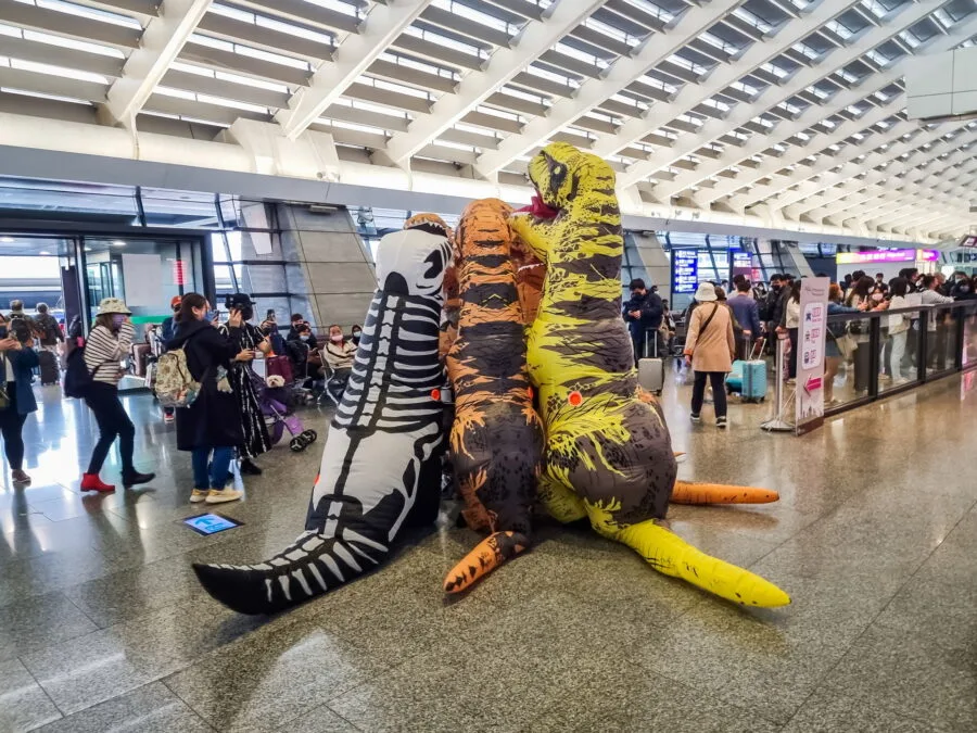 welcoming group in dinosaur costumes taipei airport