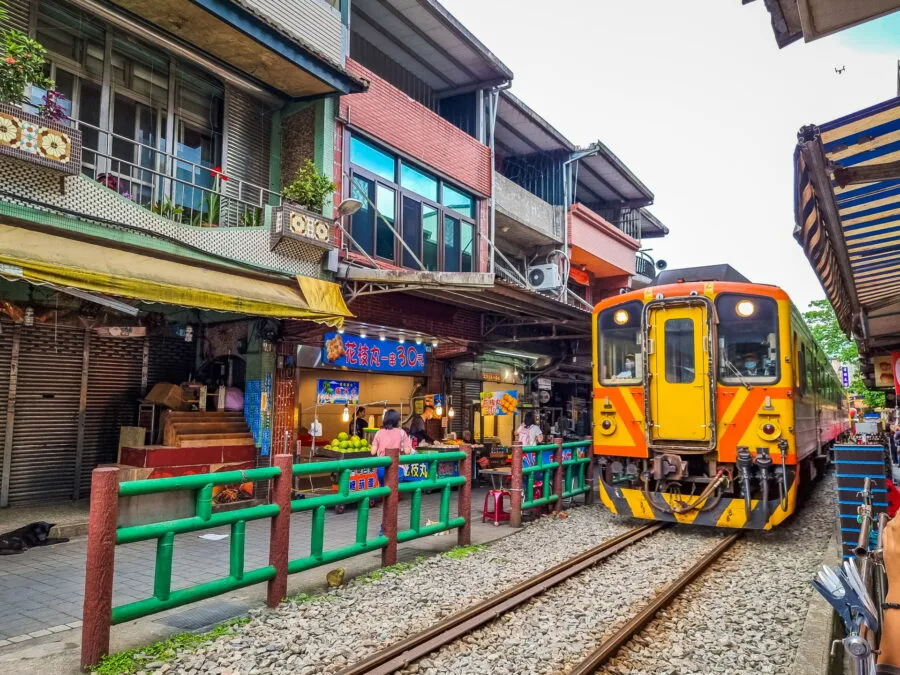 train passing in the middle of shifen taiwan