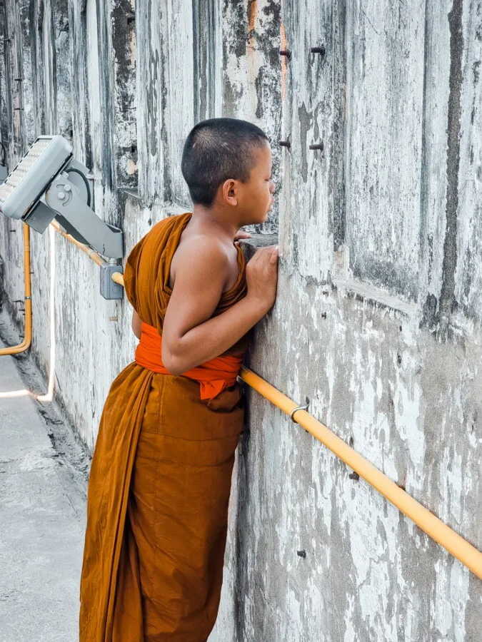 monk observing view from patuxai vientiane