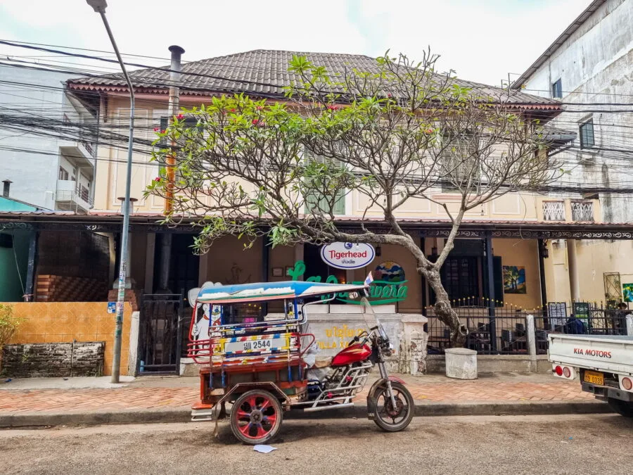 tuk tuk in front of house on vientiane street