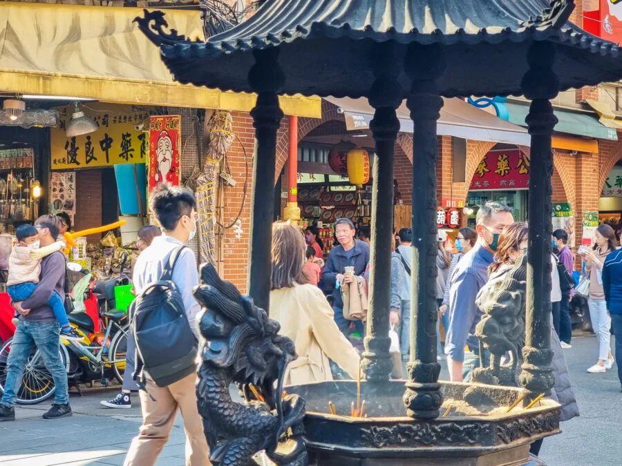 burning incense in front of Xiahai City God Temple dihua stree