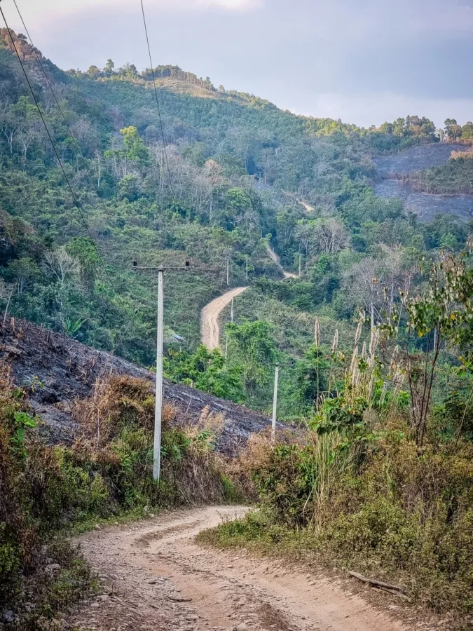 winding road mountain descent village ban pa kam nan thailand