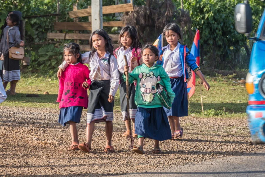 schoolchildren on the roadside between paksong and thateng laos